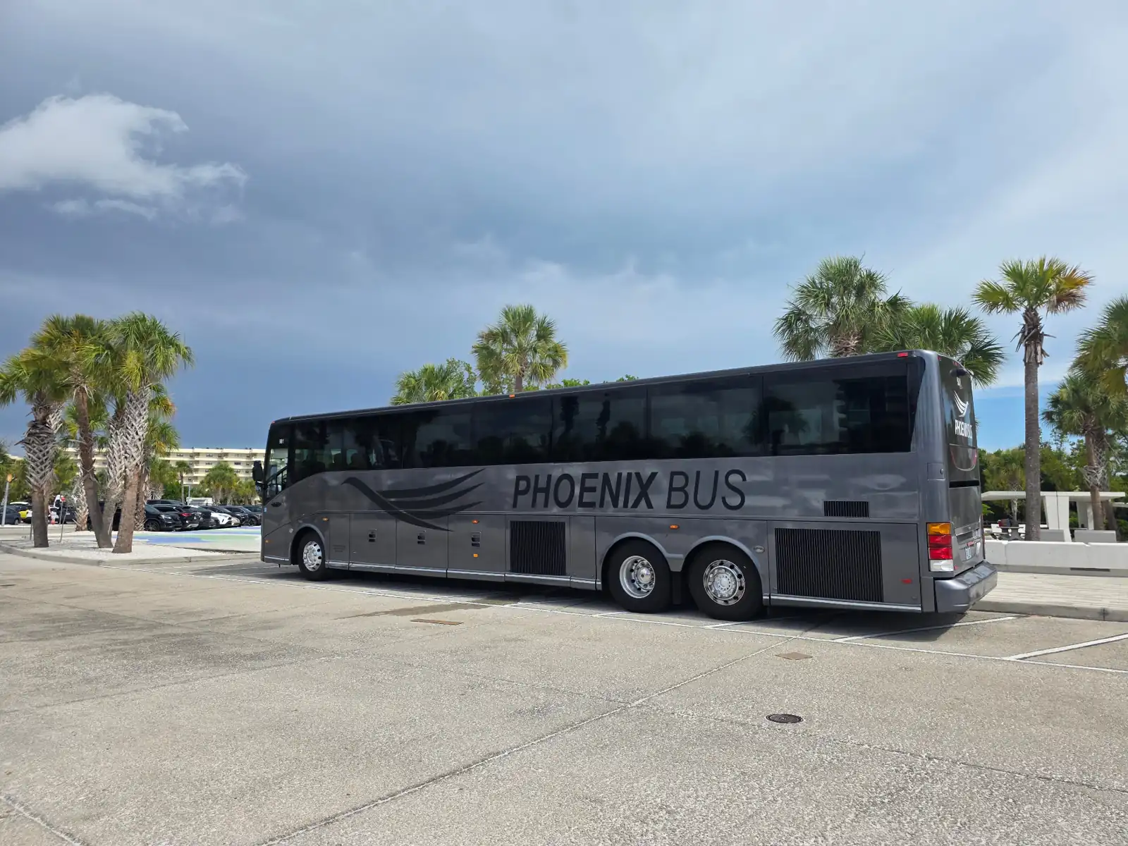 Phoenix Bus 56-passenger motorcoach at Siesta Key Beach, Florida for large-group beach day transportation