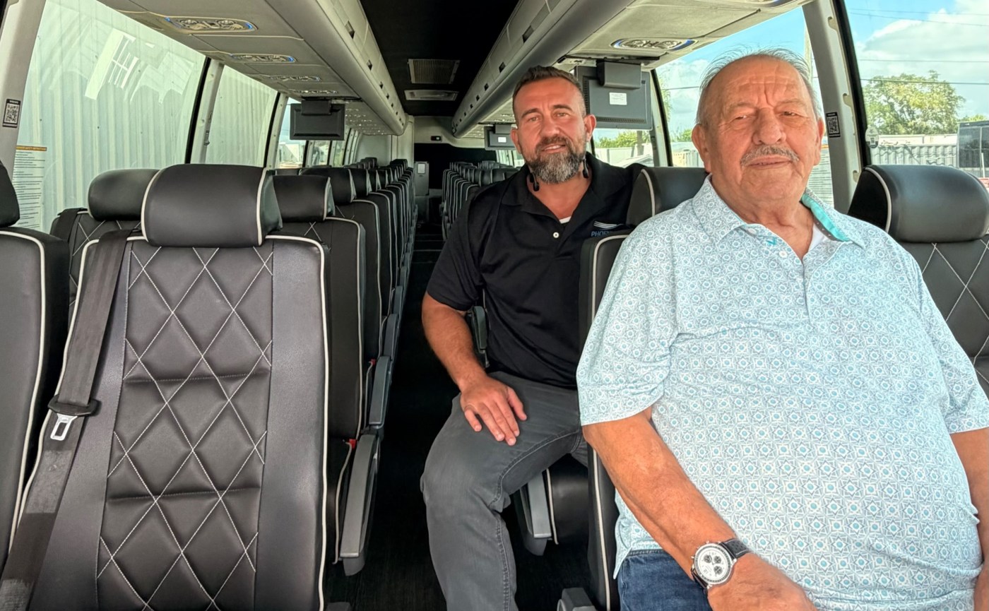Wagner Triska Sr. and Wagner Triska Jr. seated inside a Phoenix Bus motorcoach.