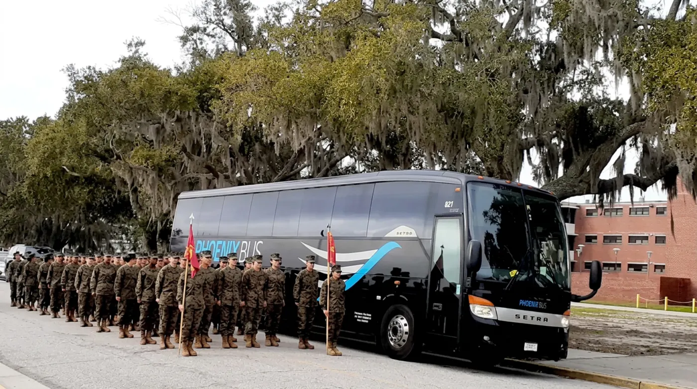 U.S. Marines in formation beside a Phoenix Bus Orlando Setra motorcoach during a military transportation mission
