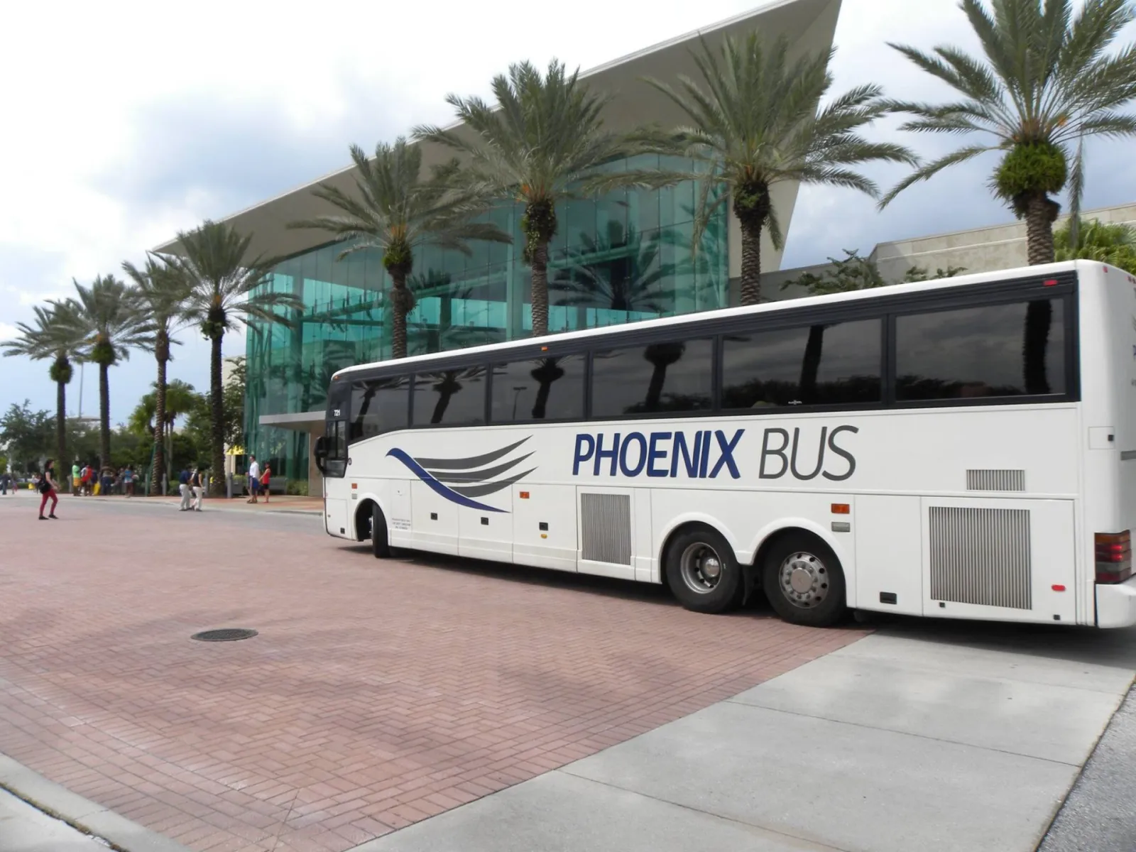 Phoenix Bus Orlando 56-passenger premium coach #721 at Millenia, Orlando — DOD / DOW-Approved, GSA-Compliant fleet serving airport transfers, large-scale corporate shuttles, VIP executive sedan transfers, and school bus charters.